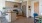 Spacious kitchen with wood floors and access to the dining area and living room.